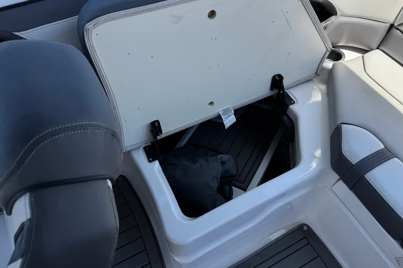Slide: The Image of 2017 Yamaha Boats 212 Limited storage compartment with open lid and seating area. - 21