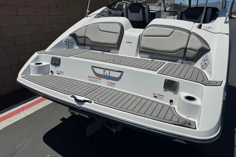 Slide: The Image of 2017 Yamaha Boats 212 Limited rear view with swim platform and seating. - 6