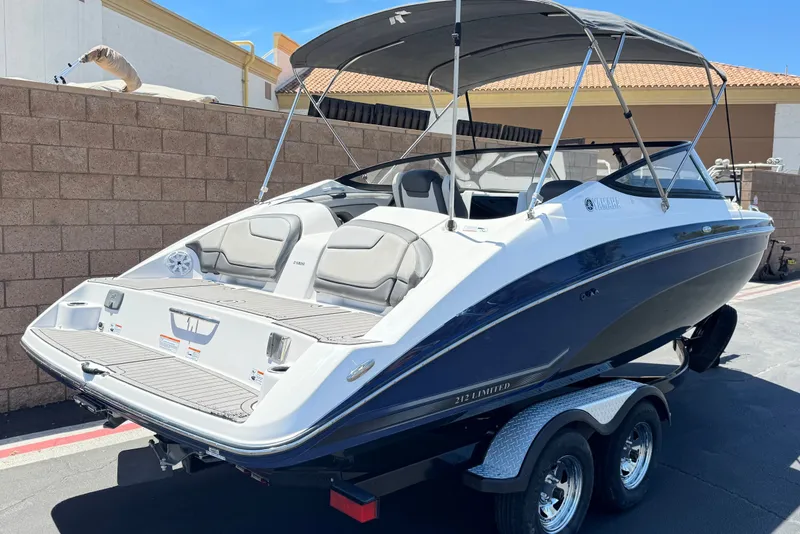 Slide: The Image of 2017 Yamaha Boats 212 Limited on trailer, featuring sleek design and spacious seating. - 5