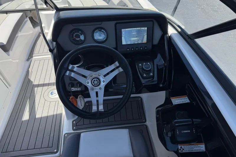 Slide: The Image of 2017 Yamaha Boats 212 Limited dashboard with steering wheel and control panel. - 27