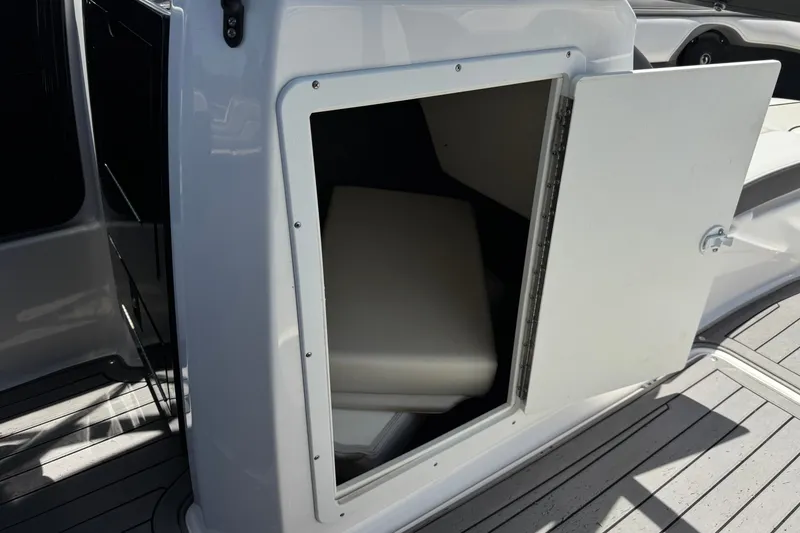 Slide: The Image of 2017 Yamaha Boats 212 Limited storage compartment with open door on deck. - 24