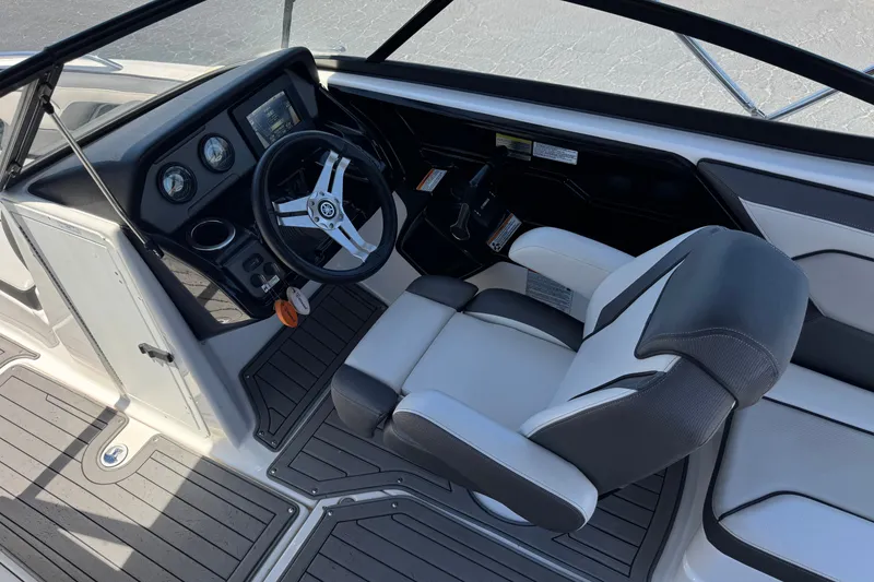Slide: The Image of 2017 Yamaha Boats 212 Limited cockpit with steering wheel and comfortable seating. - 26