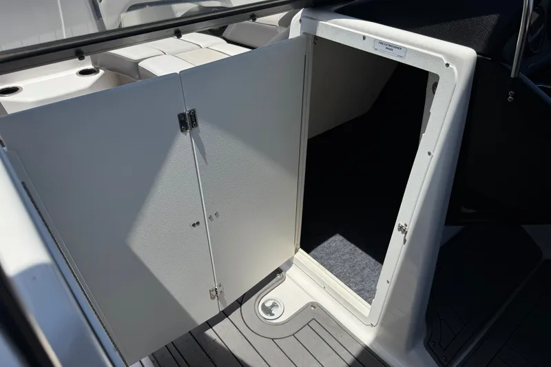 Slide: The Image of Open storage compartment on 2017 Yamaha Boats 212 Limited, featuring sleek interior design. - 34