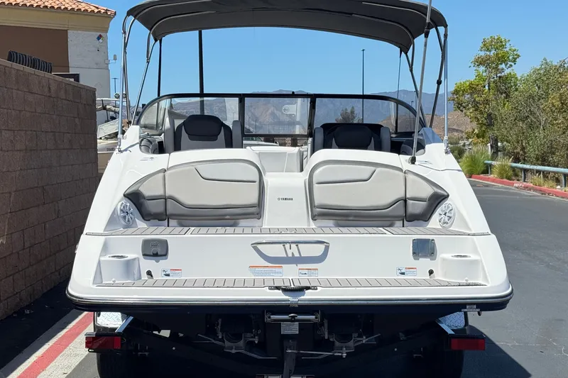 Slide: The Image of 2017 Yamaha Boats 212 Limited, rear view, parked on a sunny day. - 4