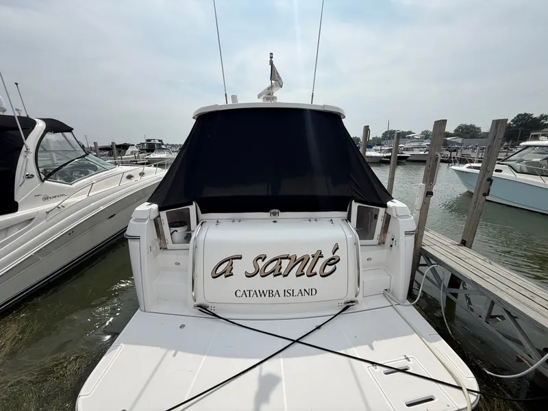 Slide: The Image of A 1999 Tiara Yachts 4000 Express docked, featuring a black cover at the stern. - 5