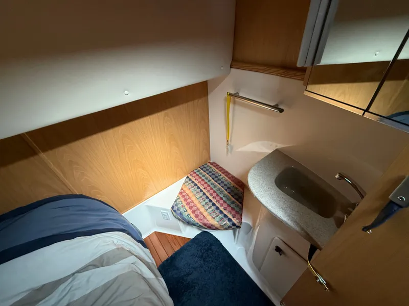 Slide: The Image of The cabin of a 1999 Tiara Yachts 4000 Express with a sink and mirror. - 37