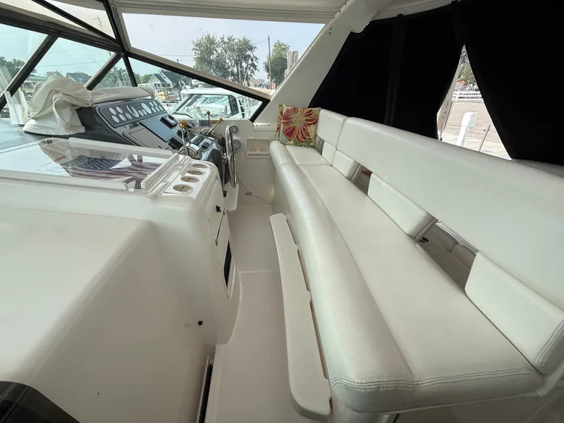 Slide: The Image of The image shows the cockpit of a 1999 Tiara Yachts 4000 Express with white leather seating. - 17