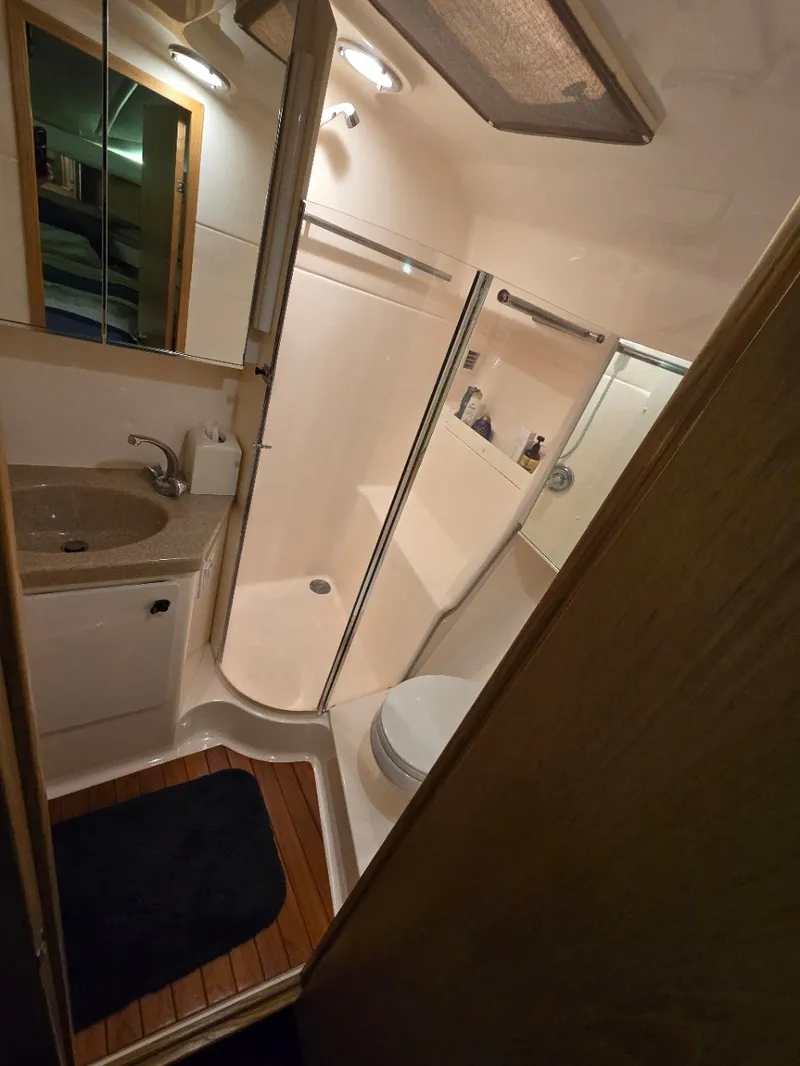 Slide: The Image of The image shows a bathroom on a 1999 Tiara Yachts 4000 Express. - 45