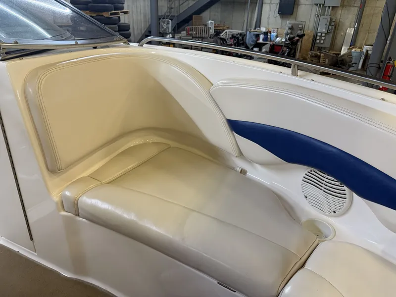 Slide: The Image of The image shows a cream-colored seating area in a boat with blue accents and a speaker. - 42