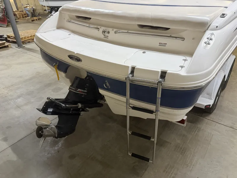 Slide: The Image of The image shows the stern of a 2001 Chaparral 219 boat with a swim ladder. - 10