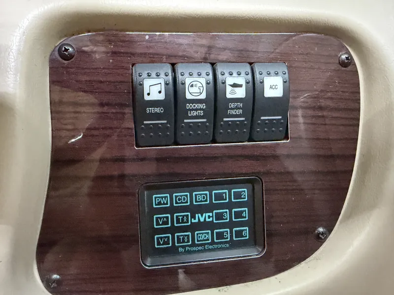Slide: The Image of A control panel with switches for stereo, docking lights, depth finder, and accessories. Below is a JVC display. - 31