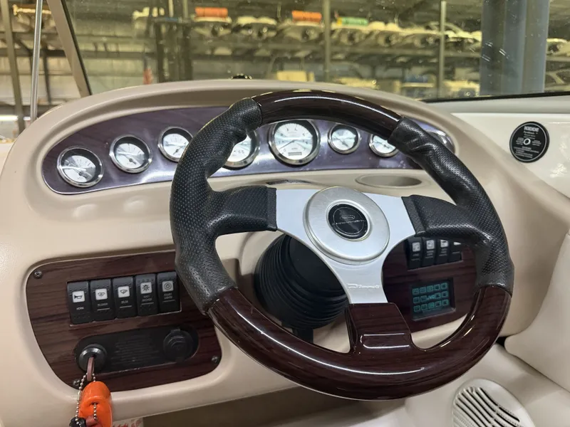 Slide: The Image of The image shows the dashboard of a 2001 Chaparral 219 boat with a sleek steering wheel. - 29