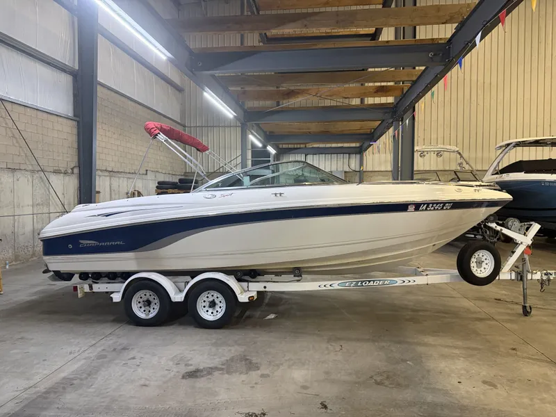 Slide: The Image of A 2001 Chaparral 219 boat on a trailer inside a warehouse. - 2