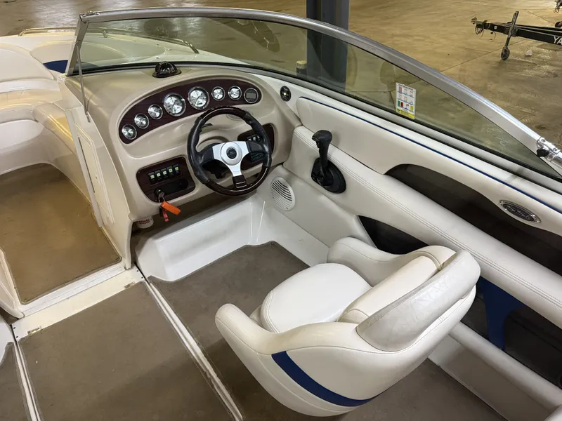 Slide: The Image of The image shows the cockpit of a 2001 Chaparral 219 boat with a sleek steering wheel and dashboard. - 26