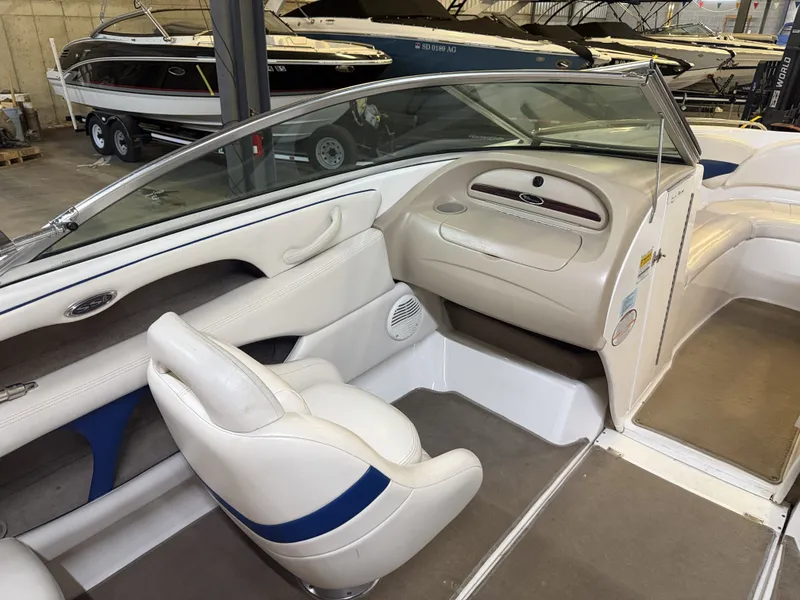 Slide: The Image of The image shows the cockpit of a 2001 Chaparral 219 boat with white seats and blue accents. - 21