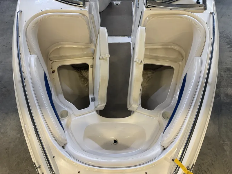 Slide: The Image of The image shows the cockpit of a 2001 Chaparral 219 boat with white seating. - 40