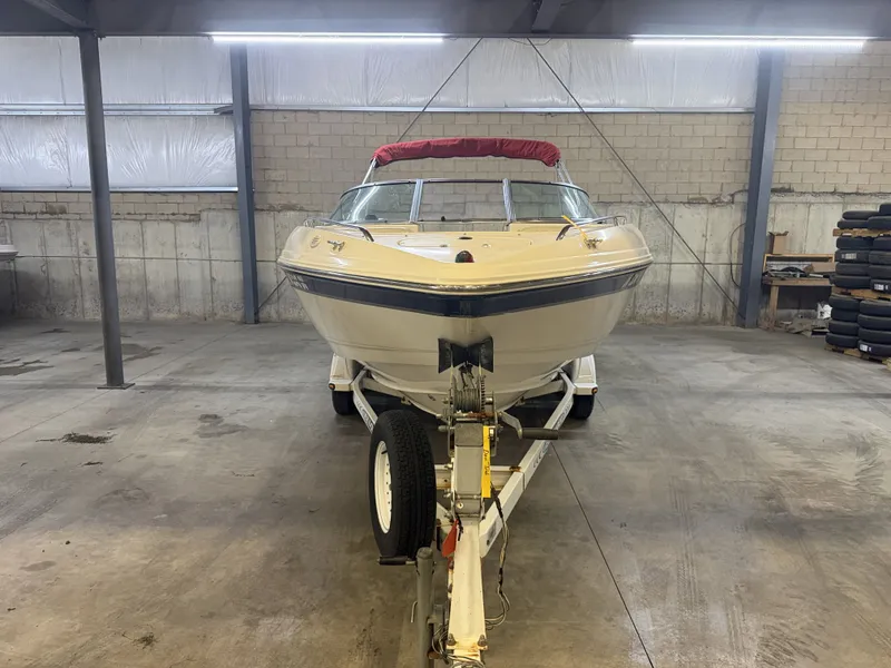 Slide: The Image of A 2001 Chaparral 219 boat on a trailer inside a warehouse. - 8