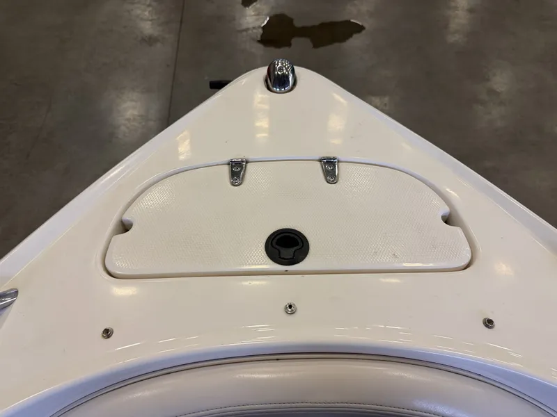 Slide: The Image of The bow of a white boat with a small storage compartment lid. - 45