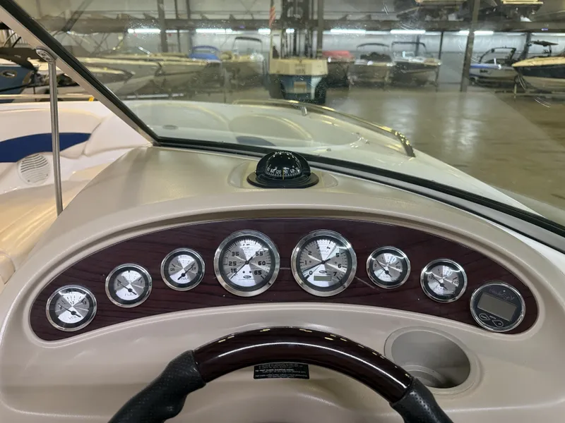 Slide: The Image of The image shows the dashboard of a 2001 Chaparral 219 boat with multiple gauges and a compass. - 32