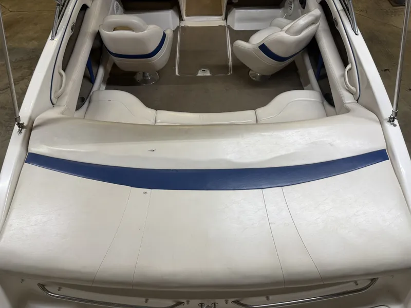Slide: The Image of The image shows the cockpit of a 2001 Chaparral 219 boat with white and blue seating. - 14