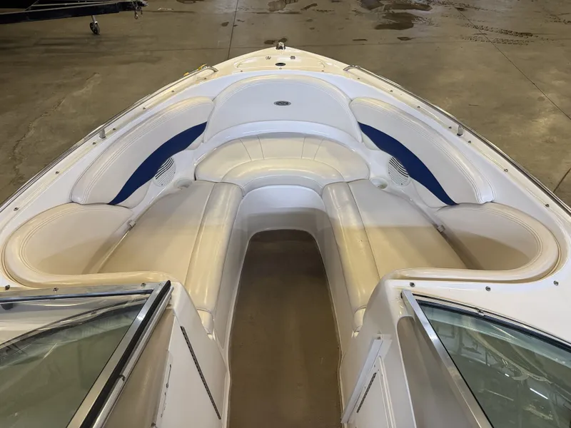 Slide: The Image of The image shows the bow of a 2001 Chaparral 219 boat with white and blue seating. - 38