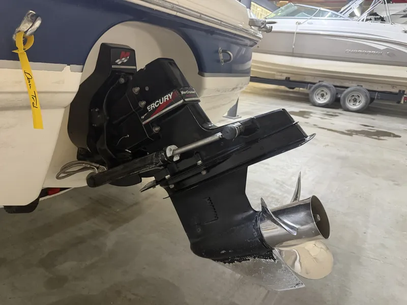 Slide: The Image of A Mercury outboard motor is attached to a Chaparral boat. Another boat is visible in the background. - 49