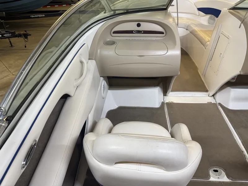 Slide: The Image of Interior of a 2001 Chaparral 219 boat with white seats and gray carpet. - 19