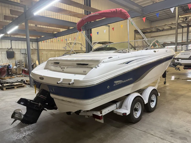 Slide: The Image of A 2001 Chaparral 219 boat on a trailer in a warehouse setting. - 3