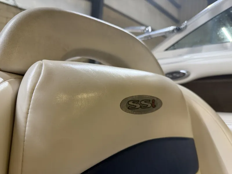 Slide: The Image of Close-up of a beige seat with "SSi" logo. A boat is visible in the background. - 24