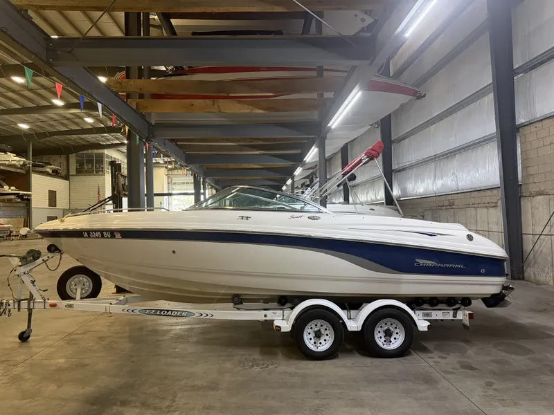 Slide: The Image of A 2001 Chaparral 219 boat on a trailer inside a warehouse. - 6