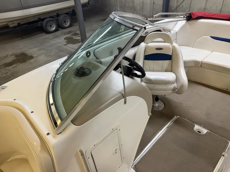 Slide: The Image of The image shows the cockpit of a 2001 Chaparral 219 boat with white seats and steering wheel. - 27