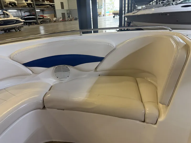 Slide: The Image of The interior of a 2001 Chaparral 219 boat features white upholstery with blue accents. - 43