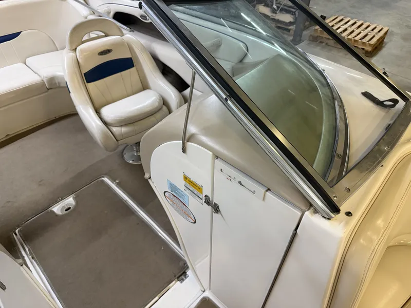 Slide: The Image of The image shows the cockpit of a 2001 Chaparral 219 boat with beige seating. - 22