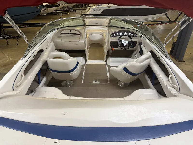 Slide: The Image of The image shows the cockpit of a 2001 Chaparral 219 boat with white and blue seating. - 13