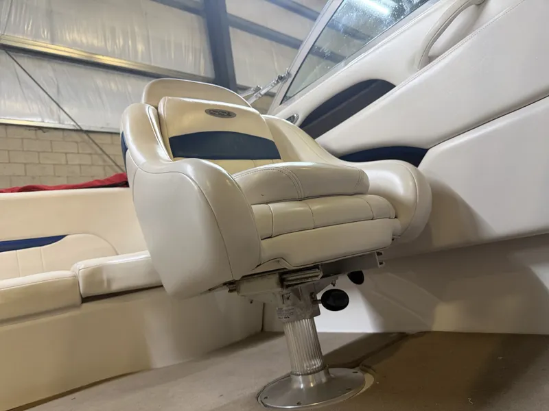 Slide: The Image of A white captain's chair in a boat with blue accents, surrounded by white upholstery. - 23