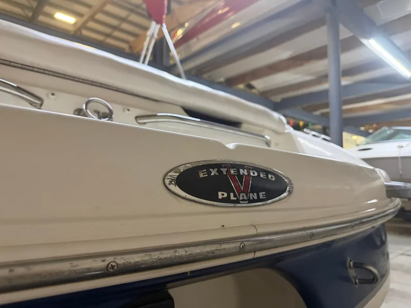 Slide: The Image of Close-up of the stern of a 2001 Chaparral 219 boat in a storage facility. - 12