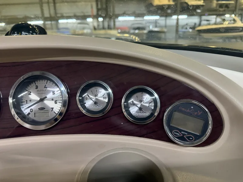 Slide: The Image of The image shows the dashboard of a 2001 Chaparral 219 boat with several gauges. - 34