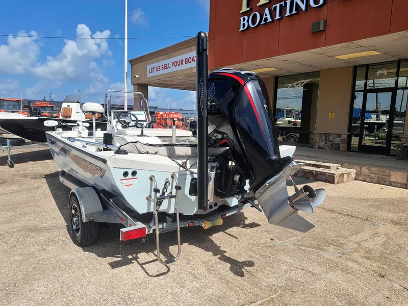 Slide: The Image of A 2022 Ranger RB190 boat on a trailer outside a building. The outboard motor is visible. - 10