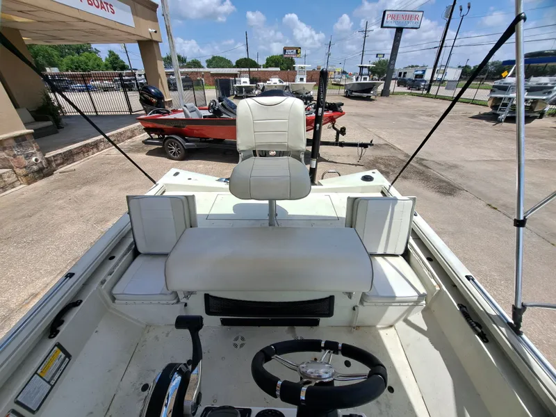 Slide: The Image of The image shows the cockpit of a 2022 Ranger RB190 boat with a white seat and steering console. - 21
