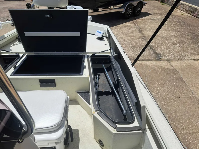 Slide: The Image of The image shows the deck of a 2022 Ranger RB190 boat with storage compartments and seating area. - 16