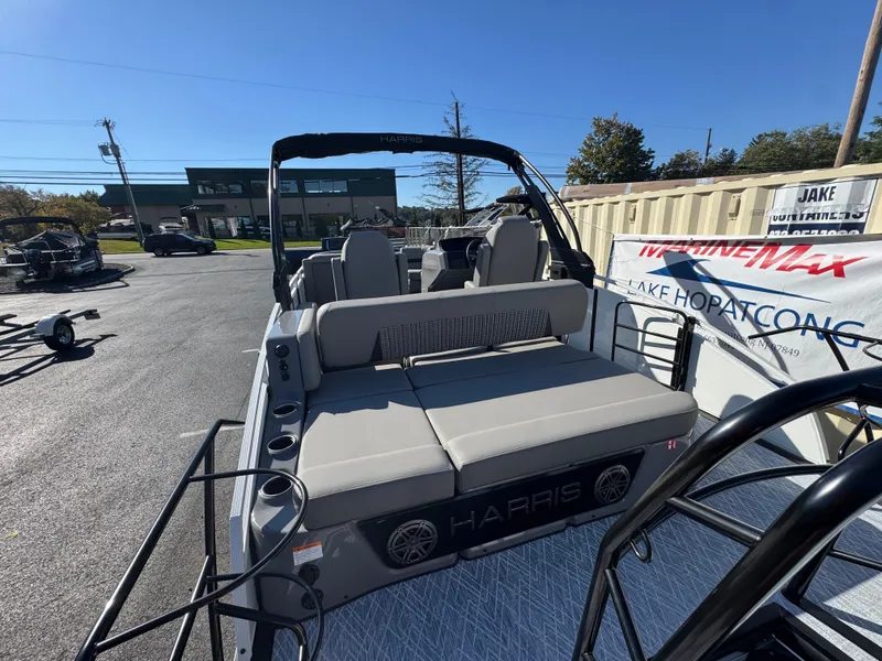 Slide: The Image of The image shows a 2027 Harris 230SOL pontoon boat with gray upholstery and a modern design. - 11