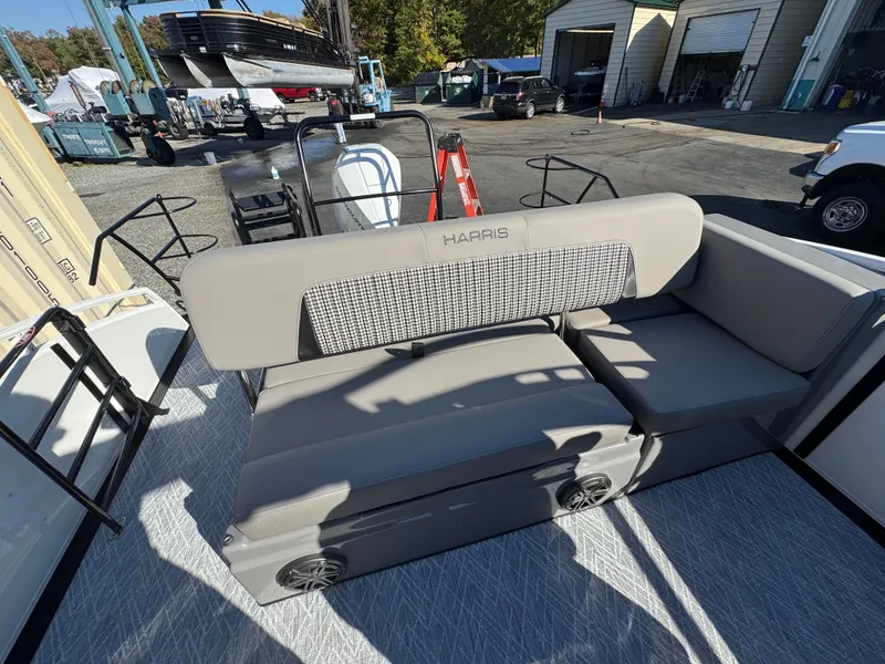 Slide: The Image of The image shows the seating area of a 2027 Harris 230SOL boat with gray upholstery. - 18