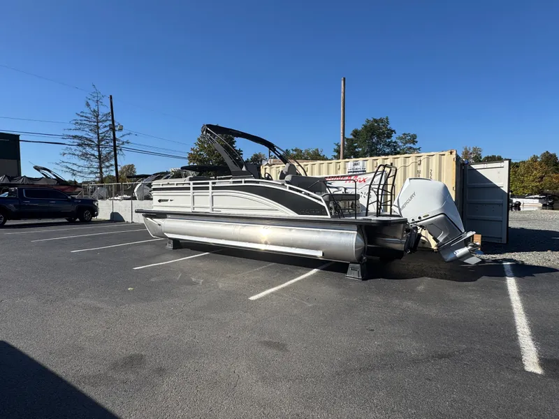 Slide: The Image of A 2027 Harris 230SOL pontoon boat is parked next to a container in a lot. - 5