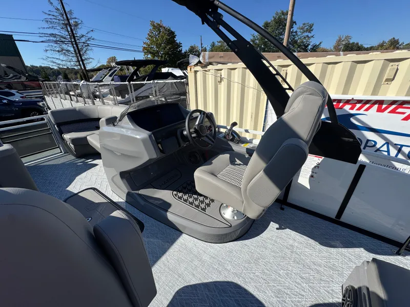 Slide: The Image of The image shows the cockpit of a 2027 Harris 230SOL with gray seats and a modern helm. - 20