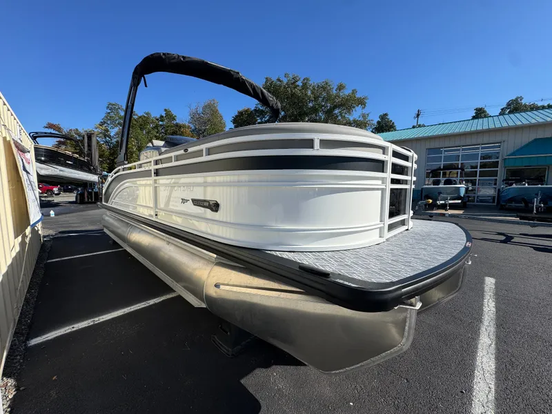 Slide: The Image of A 2027 Harris 230SOL pontoon boat is parked. It features a sleek design and modern styling. - 6