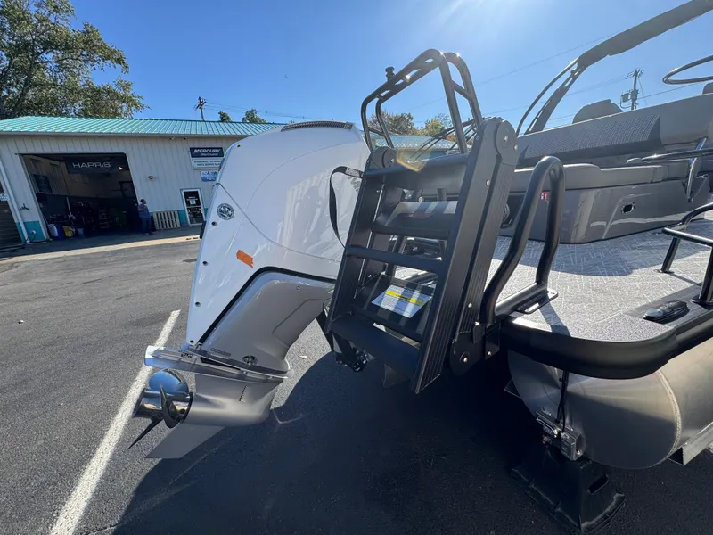 Slide: The Image of A 2027 Harris 230SOL with a powerful outboard motor and sturdy swim ladder. - 10