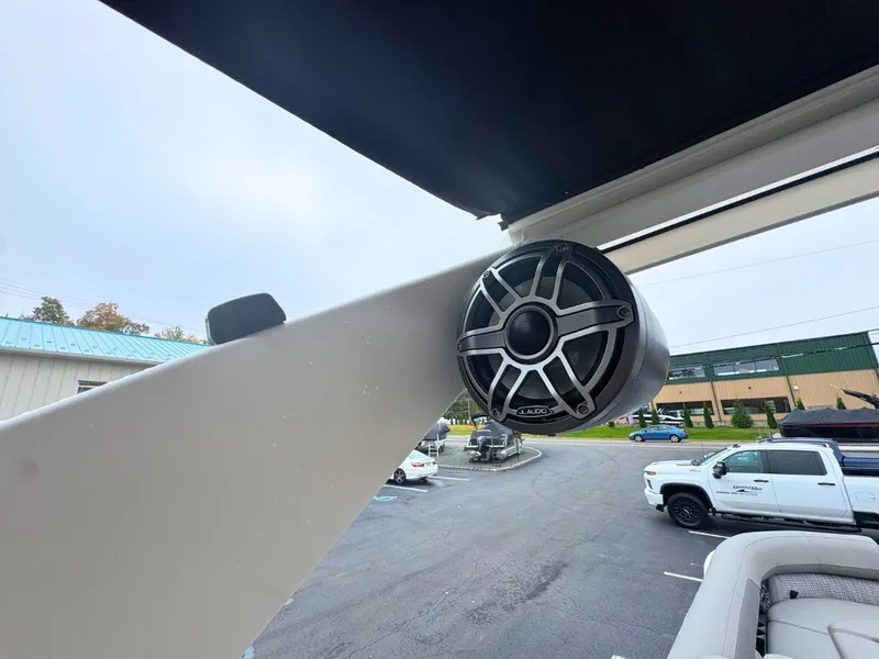 Slide: The Image of A speaker is mounted on a boat's structure, with a parking lot in the background. - 23