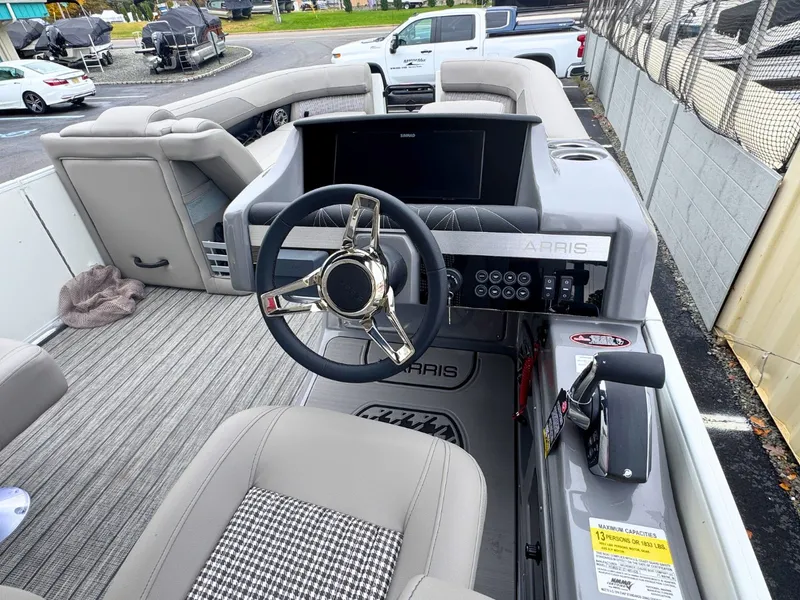 Slide: The Image of The image shows the cockpit of a 2027 Harris Grand Mariner 250 with a modern steering wheel and gray seating. - 18