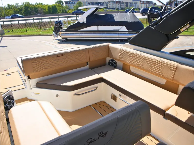 Slide: The Image of The image shows the cockpit of a 2027 Sea Ray SDX 270 Surf with beige upholstery. - 15