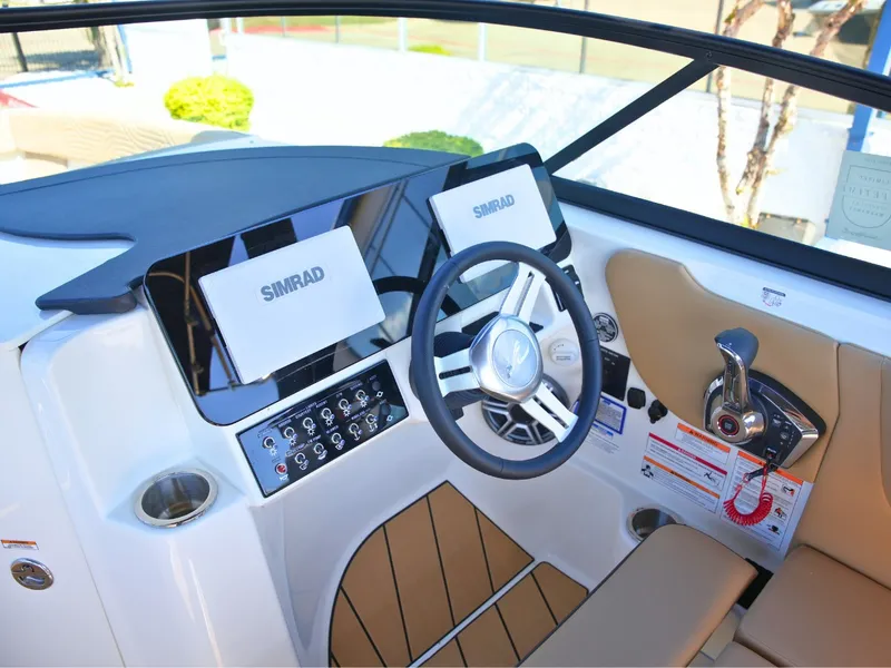 Slide: The Image of The image shows the helm of a Sea Ray SDX 270 Surf with modern Simrad displays. - 26